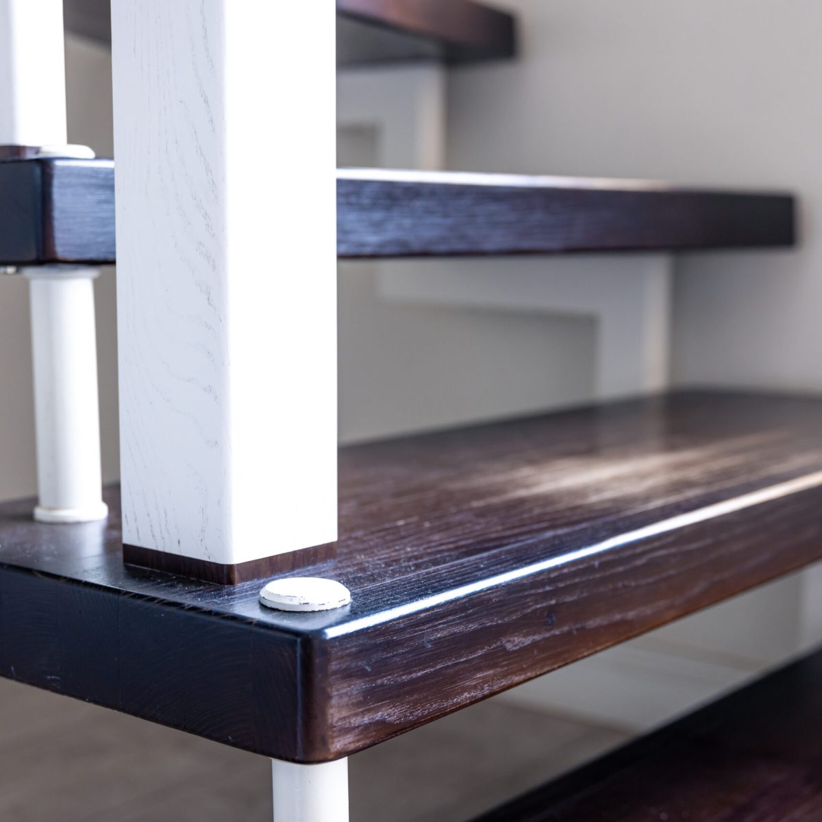 Close-up, brown and white painted wooden steps in the interior of a house.